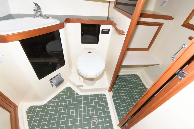 Slide: The Image of Bathroom interior of 2000 Sabreline 47 Motor Yacht with green-tiled floor. - 37