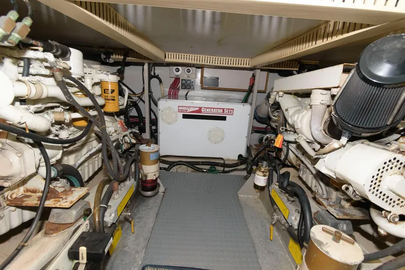 Slide: The Image of Engine room of a 2000 Sabreline 47 Motor Yacht, featuring mechanical components and generator. - 39