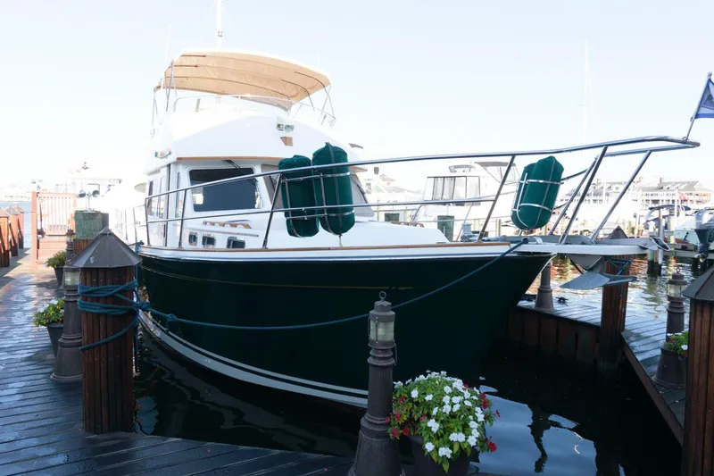 Slide: The Image of 2000 Sabreline 47 Motor Yacht docked at marina with floral decorations. - 4