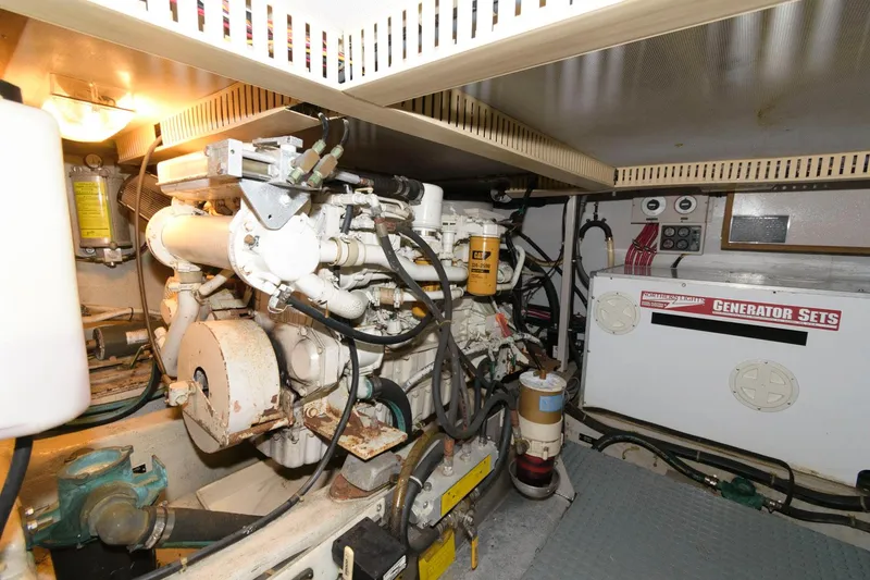 Slide: The Image of Engine room of 2000 Sabreline 47 Motor Yacht with generator and mechanical components. - 41