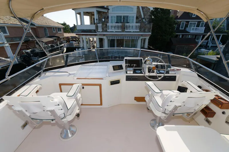 Slide: The Image of Flybridge of 2000 Sabreline 47 Motor Yacht with dual captain chairs and control panel. - 7