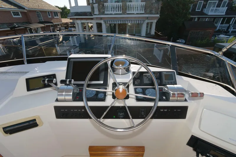 Slide: The Image of Helm of 2000 Sabreline 47 Motor Yacht with navigation instruments and steering wheel. - 8