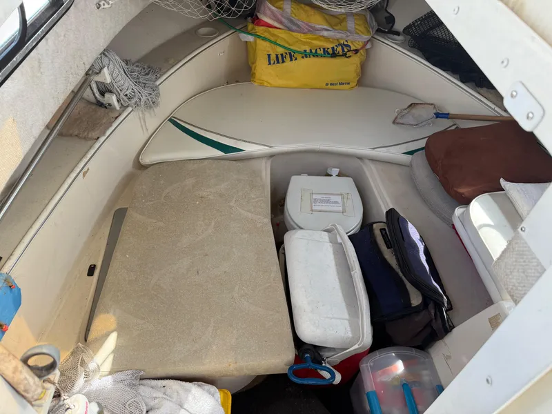 Slide: The Image of 2004 Aquasport 250 Explorer cabin with storage, coolers, and life jackets. - 12