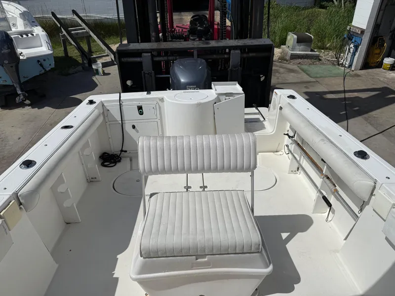 Slide: The Image of 2004 Aquasport 250 Explorer boat interior with seating and storage compartments. - 15