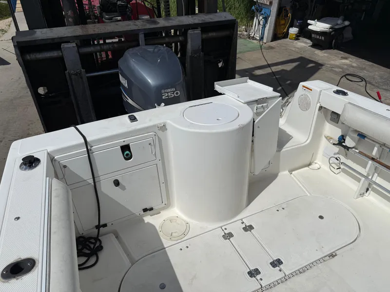 Slide: The Image of 2004 Aquasport 250 Explorer boat interior with Yamaha 250 engine, featuring storage and seating areas. - 16