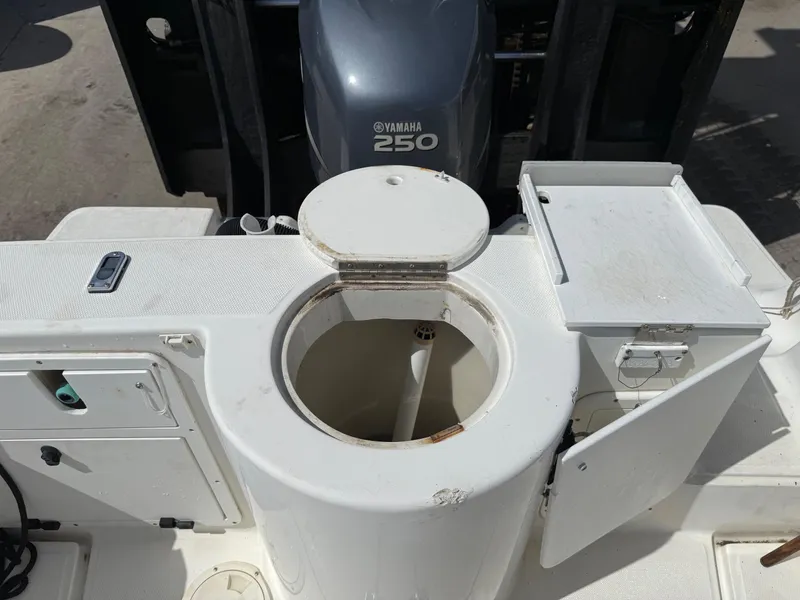Slide: The Image of 2004 Aquasport 250 Explorer boat deck with Yamaha 250 engine, storage compartments open. - 18