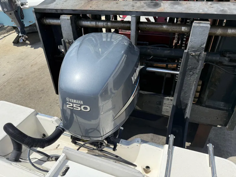 Slide: The Image of 2004 Aquasport 250 Explorer with Yamaha 250 outboard motor on lift. - 21