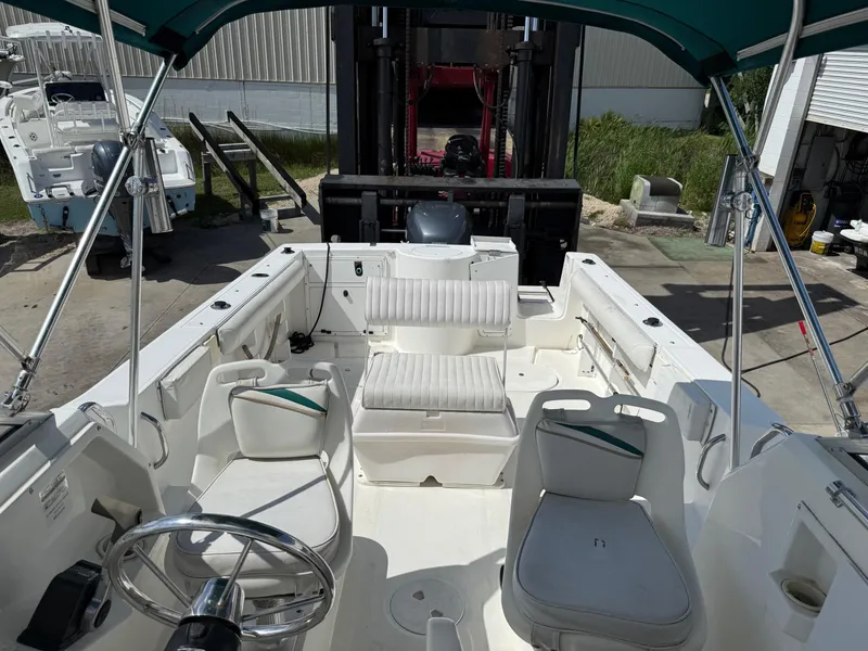 Slide: The Image of 2004 Aquasport 250 Explorer boat interior with seating and steering wheel. - 24