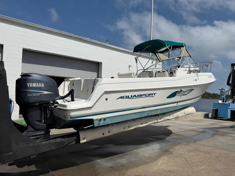 Slide: The Image of 2004 Aquasport 250 Explorer boat with Yamaha outboard motor on a lift. - 7