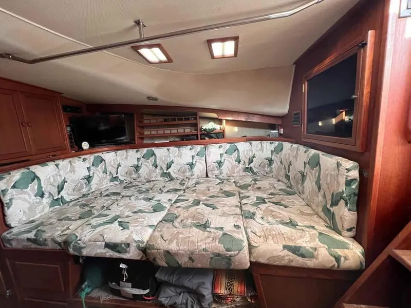 Slide: The Image of Interior of 1988 Topaz 37 Sportfisherman with floral-patterned seating and wooden cabinetry. - 4