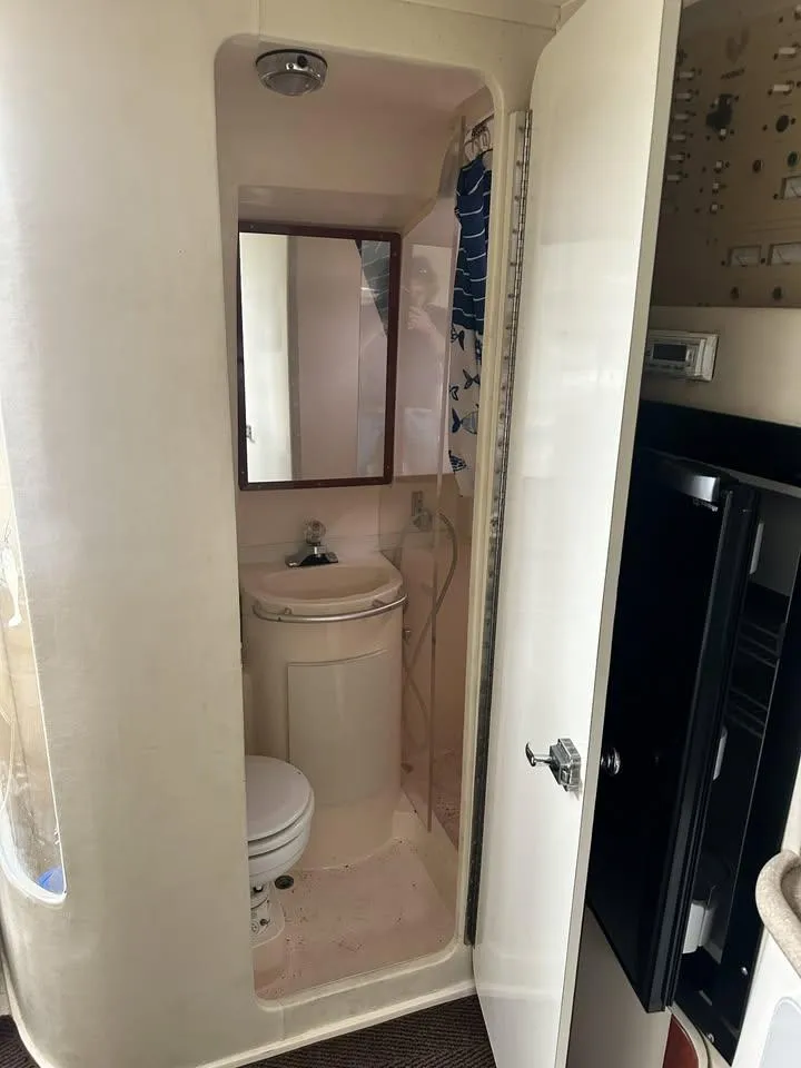 Slide: The Image of 1997 Phoenix 32 Tournament boat bathroom with sink, mirror, and toilet. - 11