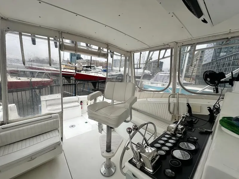 Slide: The Image of Interior of a 1997 Phoenix 32 Tournament boat with helm and seating area. - 4