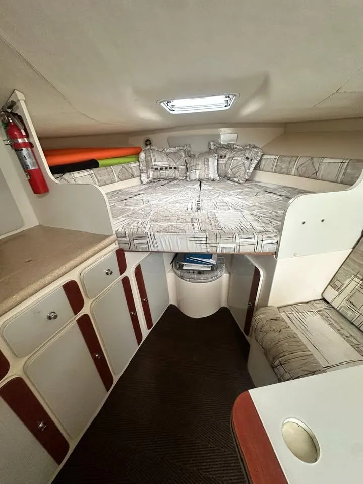Slide: The Image of 1997 Phoenix 32 Tournament cabin interior with bed, seating, and storage. - 6