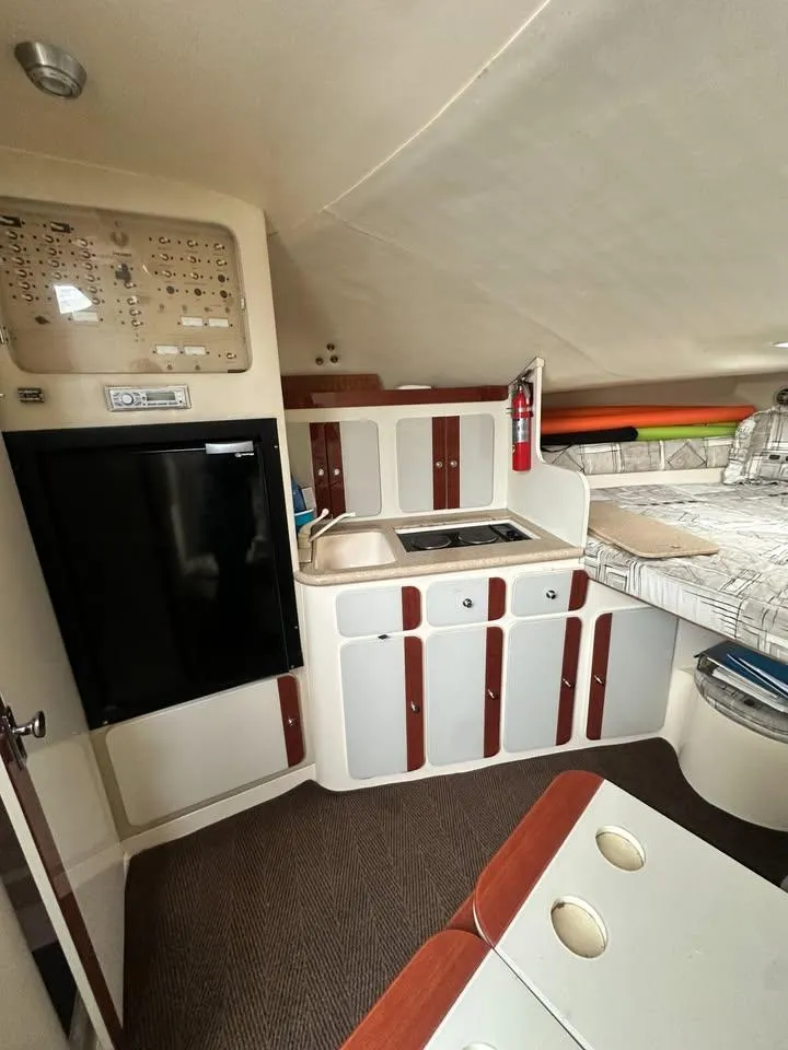 Slide: The Image of Interior of 1997 Phoenix 32 Tournament boat with kitchenette and sleeping area. - 8