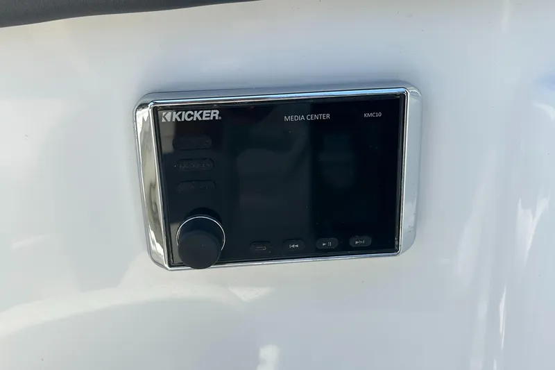 Slide: The Image of Kicker media center on 2018 Rinker 26QX BR boat dashboard. - 5