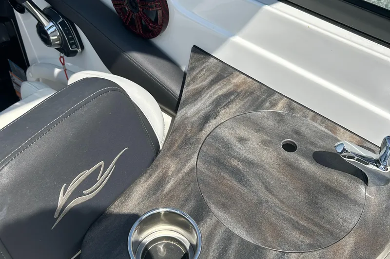 Slide: The Image of 2018 Rinker 26QX BR boat interior with sink and cup holder. - 7