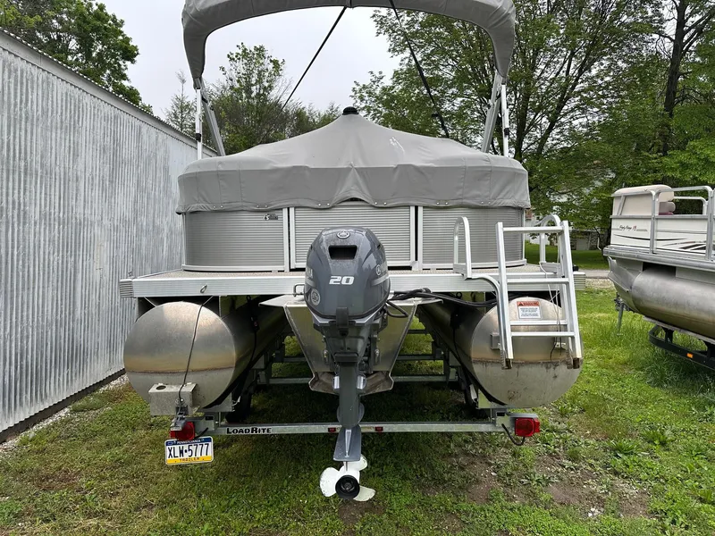 Slide: The Image of 2019 Bennington 22 SSR Quad Bench pontoon with Yamaha 25Hp engine and tandem axle trailer. - 2