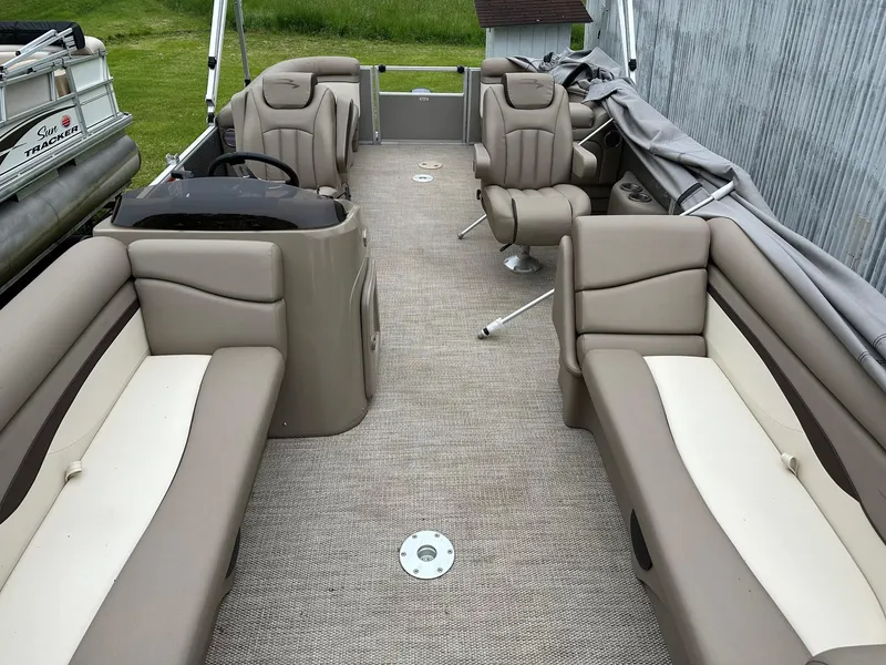 Slide: The Image of 2019 Bennington 22 SSR Quad Bench interior with beige seating and steering console. - 6