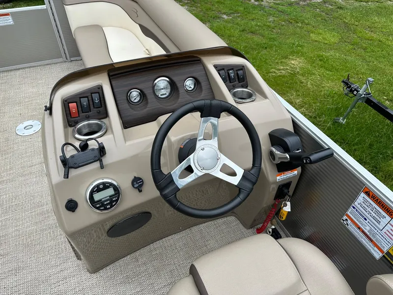 Slide: The Image of 2019 Bennington 22 SSR Quad Bench boat dashboard with steering wheel and controls. - 8