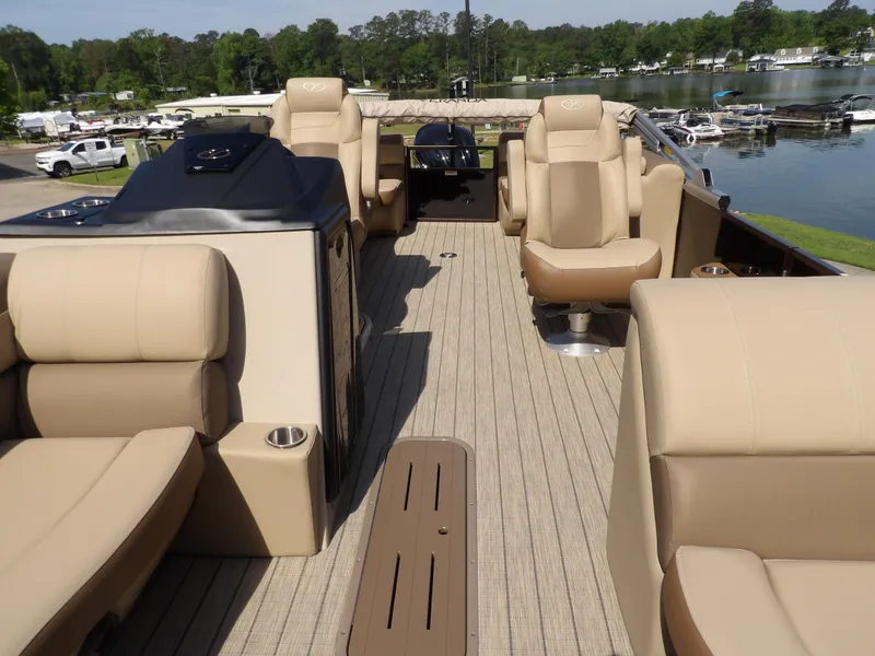 Slide: The Image of Luxurious 2025 Veranda VR22RC pontoon boat interior with plush seating and scenic lake view. - 10