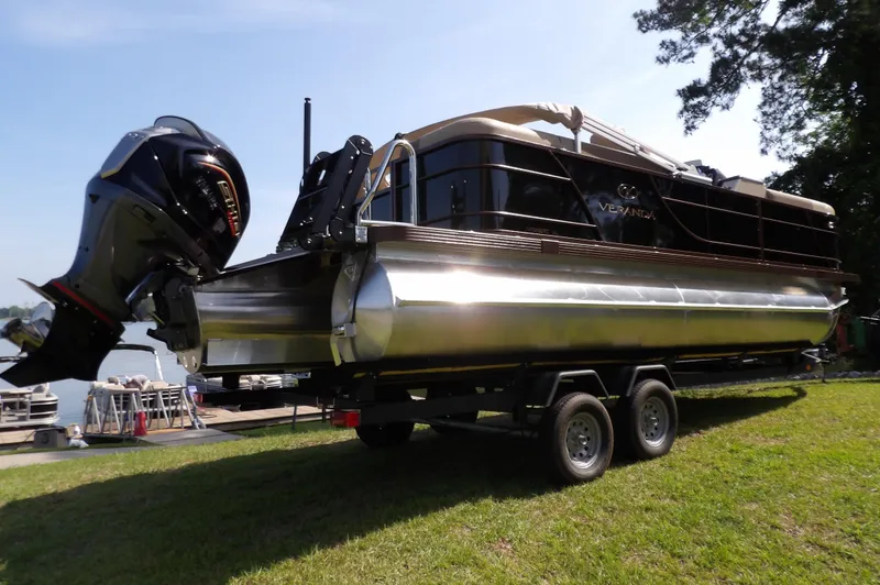 Slide: The Image of 2025 Veranda VR22RC pontoon boat on trailer, parked on grass near a lake. - 3