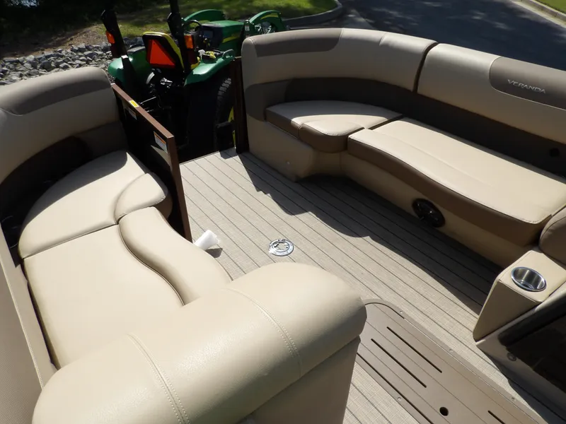 Slide: The Image of 2025 Veranda VR22RC pontoon boat interior with beige seating and wood-style flooring. - 6