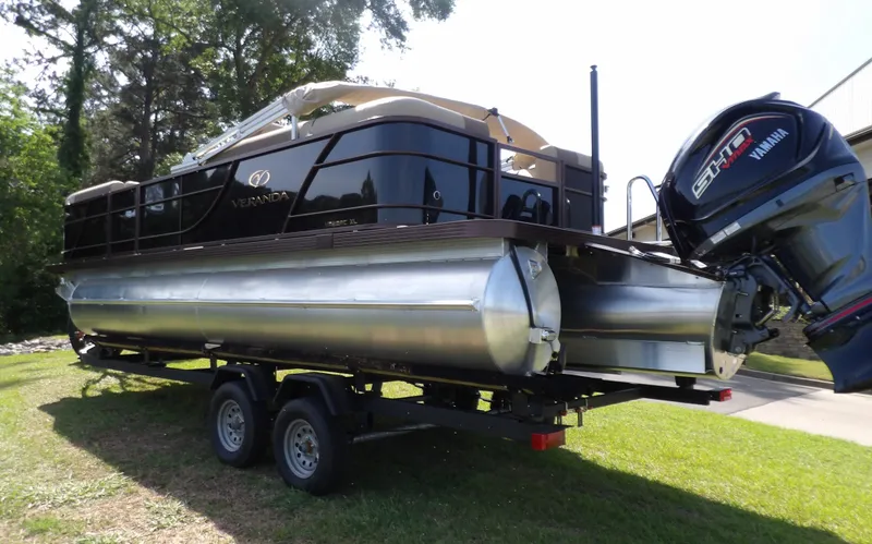 Slide: The Image of 2025 Veranda VR22RC pontoon boat on trailer with Yamaha motor, parked on grass. - 8