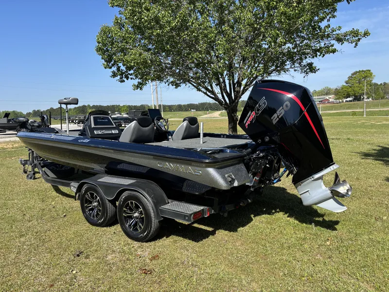 Slide: The Image of 2022 Caymas CX21 Pro boat with powerful engine, parked on grass under a tree. - 11