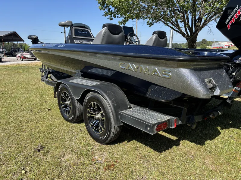 Slide: The Image of 2022 Caymas CX21 Pro boat on trailer, parked on grass, under sunny sky. - 12