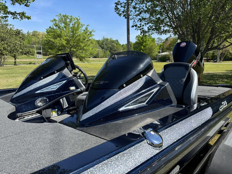 Slide: The Image of 2022 Caymas CX21 Pro boat with sleek design, parked outdoors on a sunny day. - 13