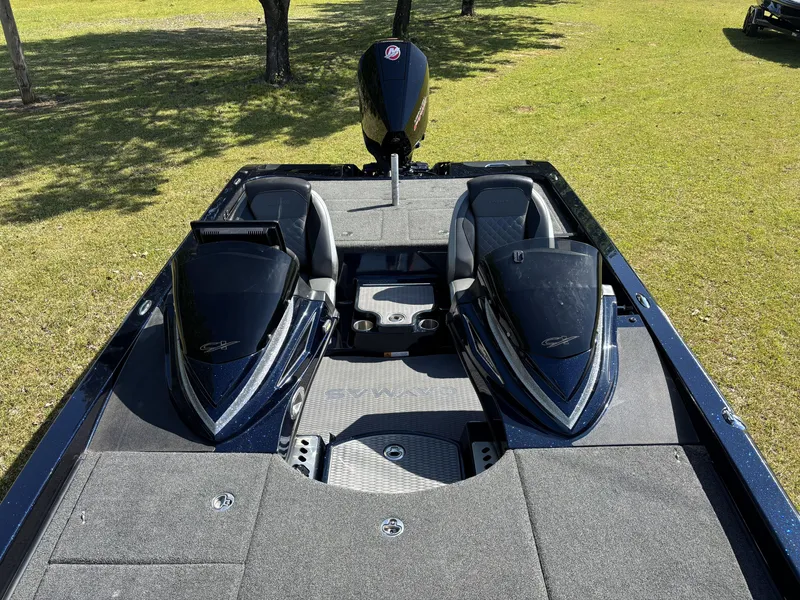 Slide: The Image of 2022 Caymas CX21 Pro boat interior with dual consoles and spacious deck on grass. - 16