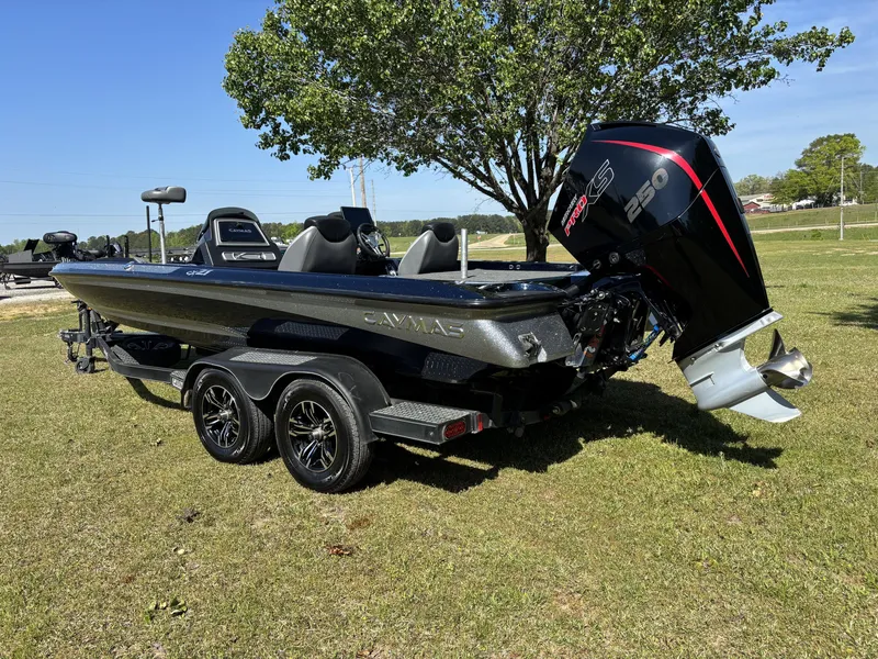 Slide: The Image of 2022 Caymas CX21 Pro boat with powerful engine, parked on grass under a tree. - 3