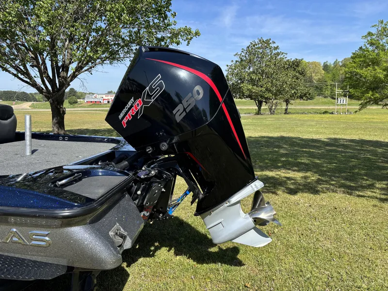 Slide: The Image of 2022 Caymas CX21 Pro boat with Mercury Pro XS 250 engine on grassy field. - 4