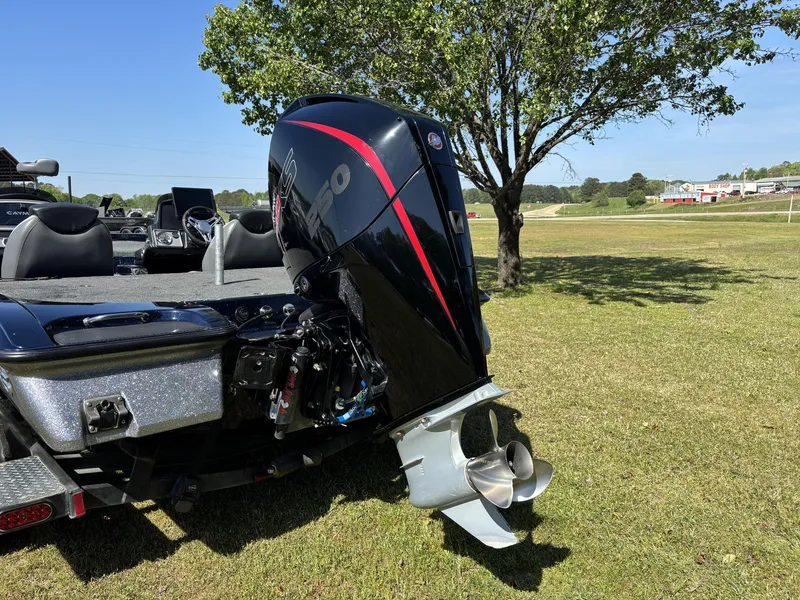 Slide: The Image of 2022 Caymas CX21 Pro boat with powerful outboard motor on grassy area. - 5
