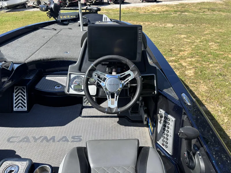 Slide: The Image of 2022 Caymas CX21 Pro boat interior with steering wheel and dashboard controls. - 8