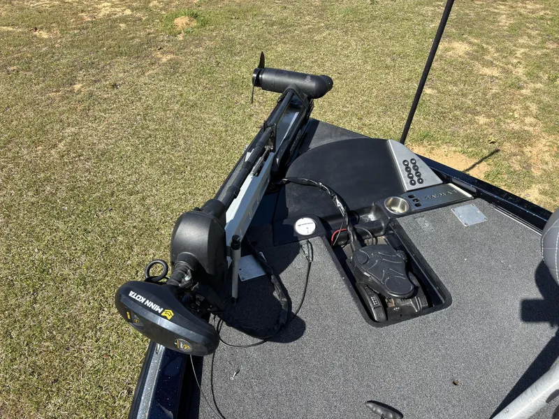 Slide: The Image of 2022 Caymas CX21 Pro boat deck with Minn Kota trolling motor on grass. - 9