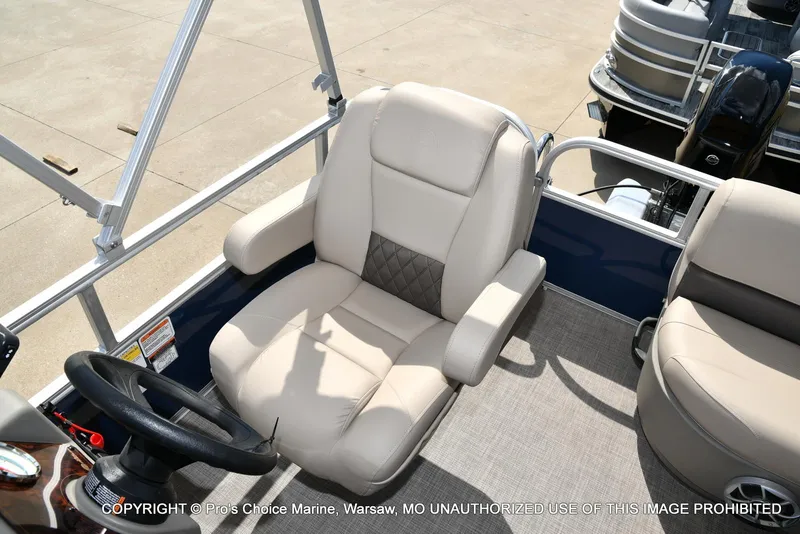 Slide: The Image of 2025 Sun Tracker Bass Buggy 16 XL Select boat interior with comfortable seating and steering wheel. - 30