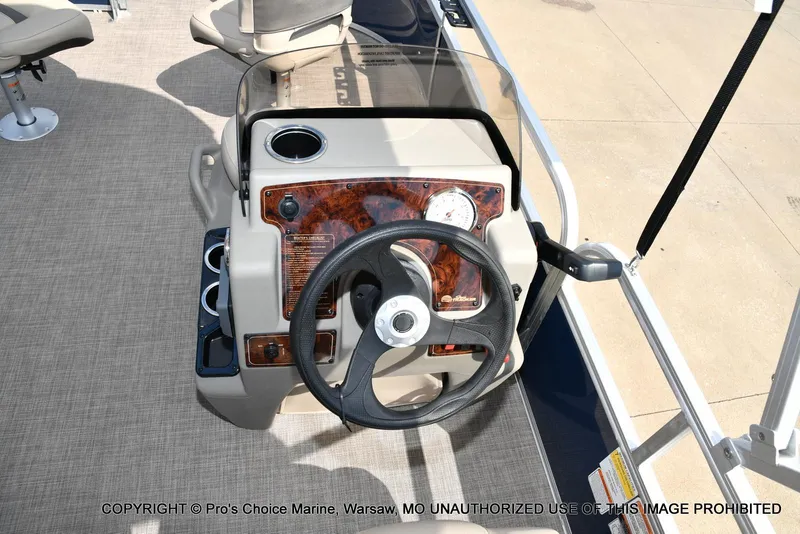 Slide: The Image of 2025 Sun Tracker Bass Buggy 16 XL Select steering console with cup holder and gauge. - 33