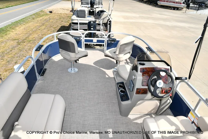 Slide: The Image of 2025 Sun Tracker Bass Buggy 16 XL Select pontoon boat interior with seating and steering console. - 37