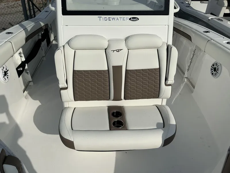 Slide: The Image of 2025 Tidewater 282CC boat interior with cushioned seating and cup holders. - 16
