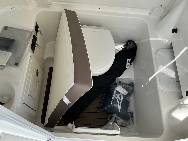 Slide: The Image of 2025 Tidewater 282CC boat interior with toilet and storage area. - 27