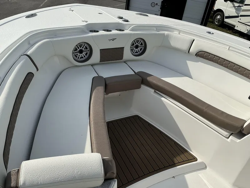 Slide: The Image of 2025 Tidewater 282CC boat interior with cushioned seating and speakers. - 31