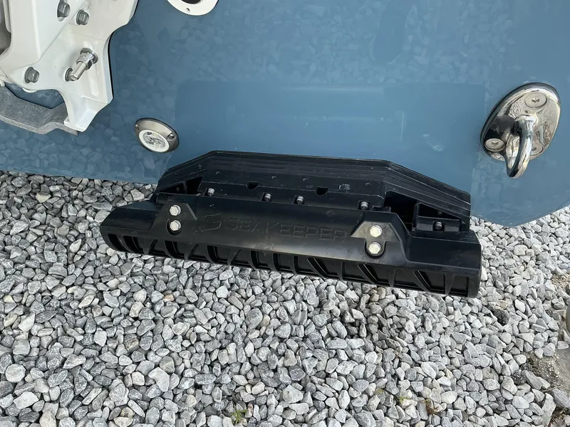 Slide: The Image of 2025 Tidewater 282CC boat with Seakeeper stabilizer on gravel surface. - 10