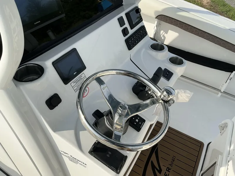 Slide: The Image of 2025 Tidewater 282CC boat helm with steering wheel and control panel. - 14