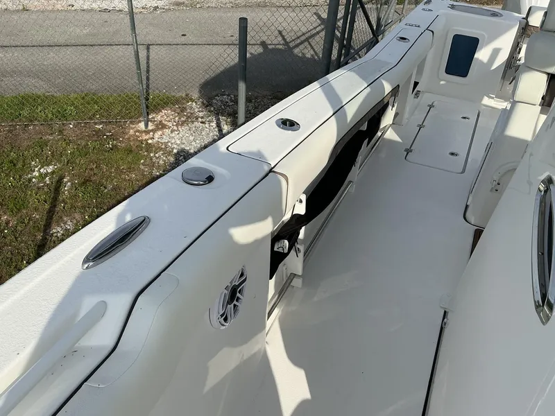 Slide: The Image of 2025 Tidewater 282CC boat interior with white seating and storage compartments. - 23