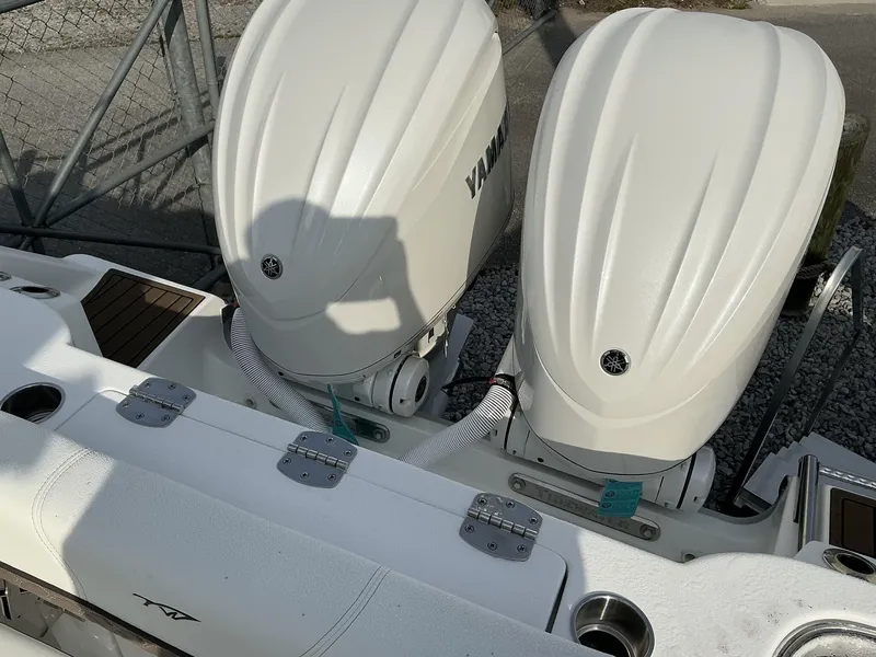 Slide: The Image of 2025 Tidewater 282CC boat with dual Yamaha outboard engines, docked on gravel. - 32
