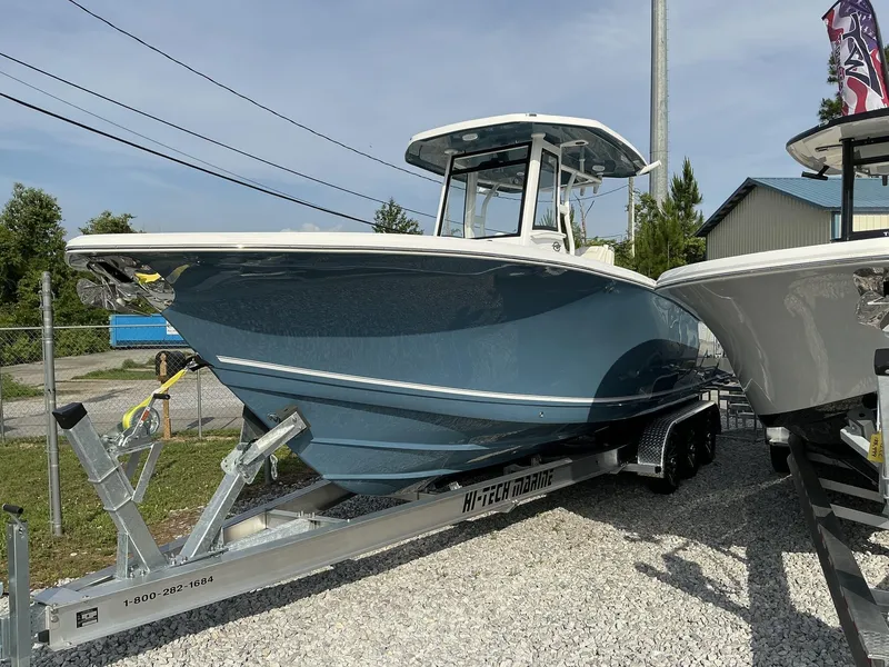 Slide: The Image of 2025 Tidewater 282CC boat on trailer, displayed outdoors, under clear sky. - 4