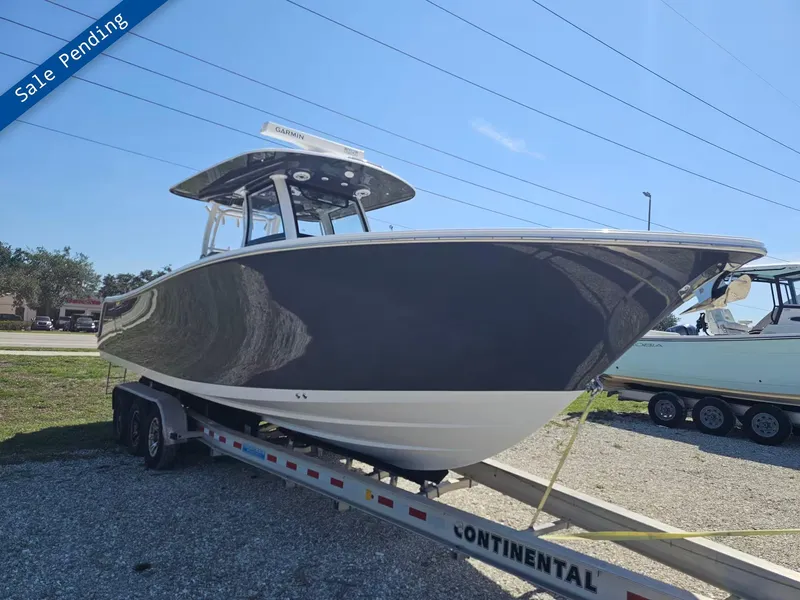 Slide: The Image of 2021 Sportsman 302 CC boat on trailer, sale pending, clear sky background. - 1