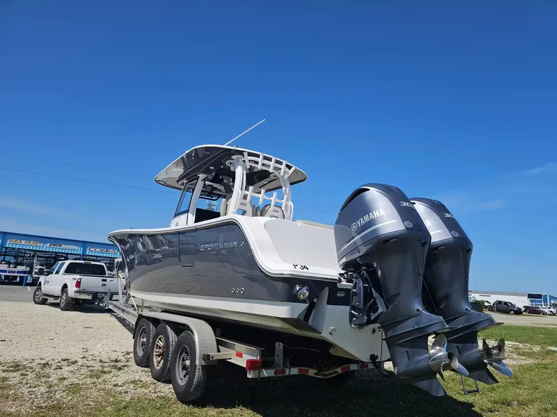 Slide: The Image of 2021 Sportsman 302 CC boat with dual Yamaha engines on a trailer. - 3