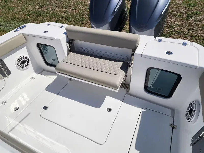 Slide: The Image of 2021 Sportsman 302 CC boat interior with foldable seat and dual engines. - 6
